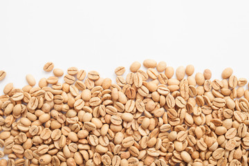 Grains of green coffee on a white background