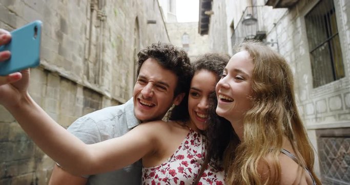 Best friends taking selfie using smartphone in Barcelona on Vacation enjoying European summer holiday travel adventure