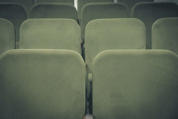 Obraz premium Conference hall or cinema interior with rows of green chairs