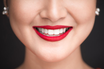 Beauty. Close up view of beautiful woman lips with red matt lipstick