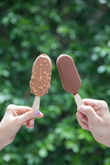 chocolate coated ice cream on green background