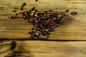 Obraz na płótnie Canvas Different pepper spices on wooden table