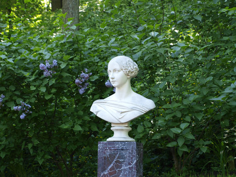 White Marble Statue Bust Of Woman With Green Background Copyspace