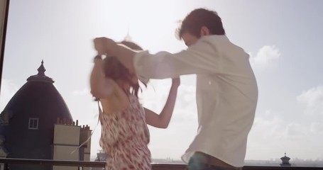 Happy tourist couple dancing silly freestyle dance in Paris in front of Eiffel Tower enjoying vacation celebrating honeymoon travel adventure - Powered by Adobe