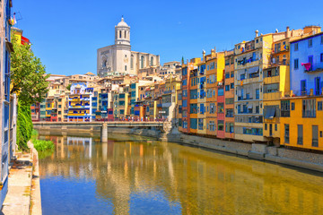 Colorful yellow and orange houses in historical jewish quarter of Girona, Catalonia, Spain. Saint Mary Cathedral.