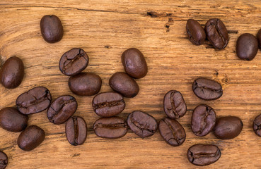 Roasted coffee beans on wood texture background. vintage color effected