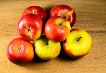 Pile of the apples on wooden table