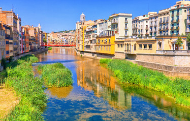 Colorful yellow and orange houses in historical jewish quarter of Girona, Catalonia, Spain.