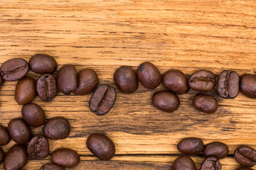 Roasted coffee beans on wood texture background. vintage color effected