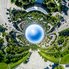Aerial city view with crossroads, roads, houses, buildings, parks and parking lots. Copter drone helicopter shot. Panoramic wide angle image.
