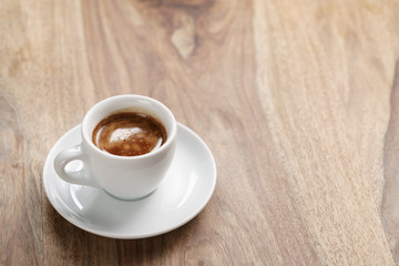 cup of fresh espresso on wood table with copy space, shallow focus
