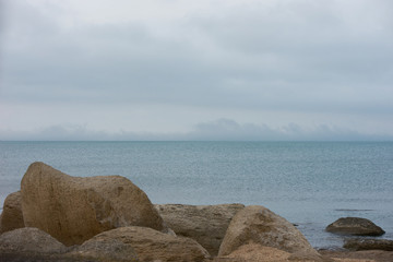 Classic spring picture of caspian sea with montains, rocks and Gloomy blue sky, Baku , Azerbaijan