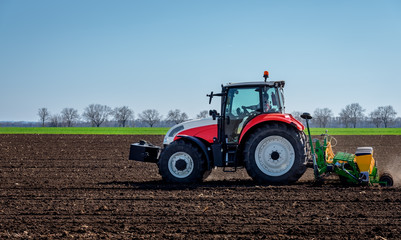 Agriculture tractor sowing seeds and cultivating field