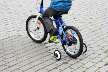 A boy rides on a bike.