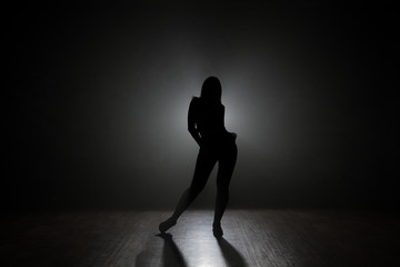 Fototapeta na wymiar Dancer posing backlit.