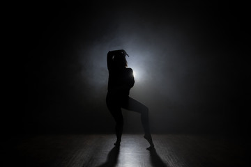 Silhouette of a dancer girl on a black background