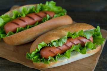Hotdogs on a wooden board. Photo closeup.