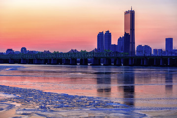 The sun sets behind the skyscrapers of Hangung river in seoul,South Korea
