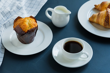 Breakfast. Coffee with milk muffin and croissants.