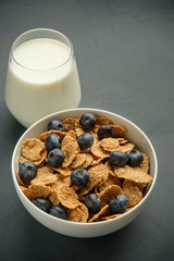 Healthy food. Milk, multi grain flakes with blueberry for breakfast.