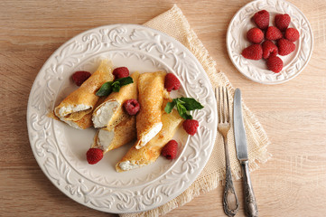 pancakes with cottage cheese and raspberries on a plate