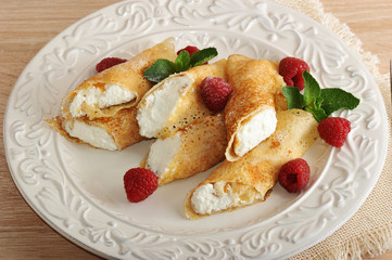 pancakes with cottage cheese and raspberries on a plate