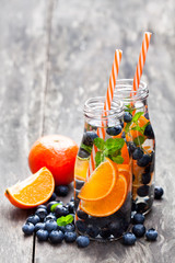 detox  organic blueberry and orange drink on wooden background