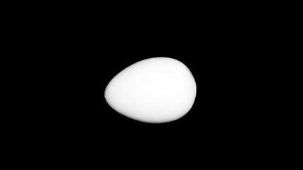 White egg on a black background - the contrast of the isolated object. Figure gypsum for natural abstract art.