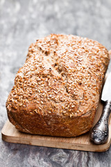 Homemade  wholemeal rye bread with flax seeds on wooden table