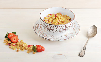bowl with corn flakes and strawberries with milk