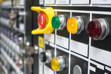 Selective focus Control panel with lots of buttons and light bulb for control and monitor process in plant or oil and gas platform. - obrazy, fototapety, plakaty