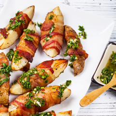 Bacon Wrapped Potatoes with Parsley Garlic Pesto Sauce. Selective focus.