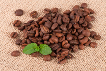 heap of coffee beans on sackcloth close-up