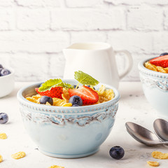Healthy breakfast - corn flakes with fruits and berries.
