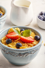 Healthy breakfast - corn flakes with fruits and berries.