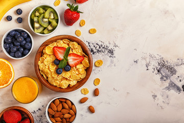 Healthy breakfast - bowl of corn flakes, berries and fruit © tbralnina