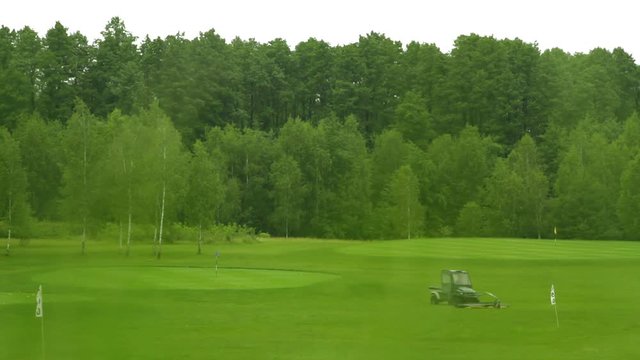 Special car collecting balls on the golf course. Motion camera shot.