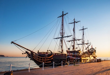 A touristic pirate ship at the pier (molo) in Sopot, Poland, in sunrise light