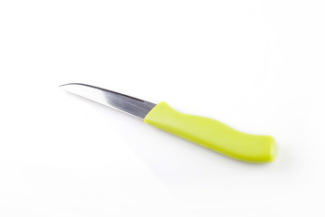 Green kitchen knife on a white surface. Kitchen tool isolated on white background.