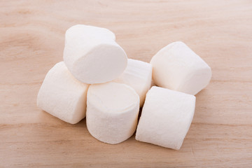 white marshmallows on wooden background
