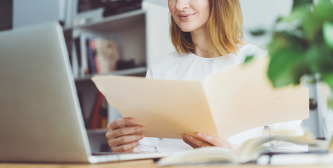 Professional manager working on new financial project, Young business woman in white shirt looking documents with the accounting report of the finance