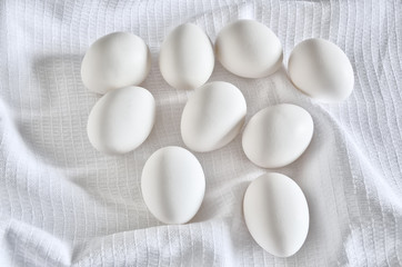 Fototapeta na wymiar Fresh white eggs close up on the cotton towel
