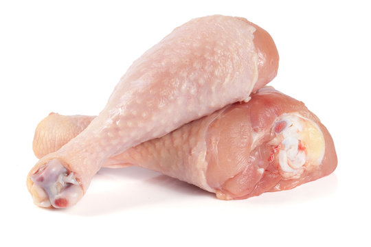 Two raw chicken drumsticks isolated on white background