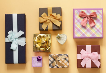 A lot of gift boxes with bows on a beige background
