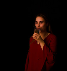 Young pretty girl drinks water Glass of mineral water  