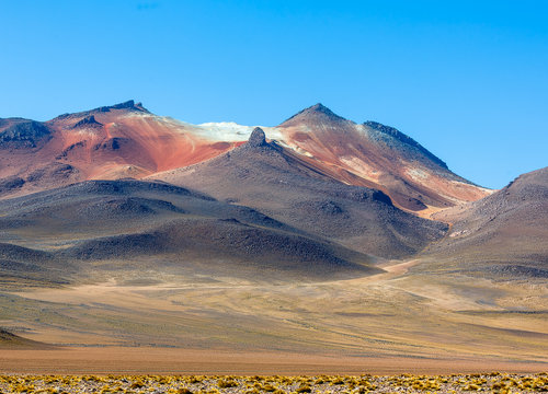 Desert plateau of the Altiplano near Laguna Verde (destroyed cone of an ancient volcano in the background) - Bolivia, South America
