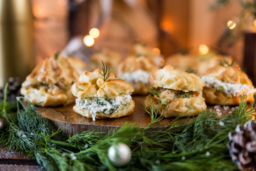 Profiteroles on wooden disk