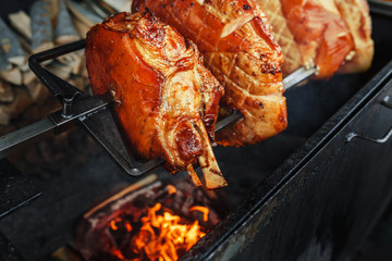 Large chunks of pork cooked on open flame