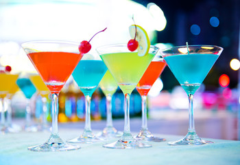 Group of colorful cocktail in martini glasses.