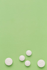 Round white pills on colorful background